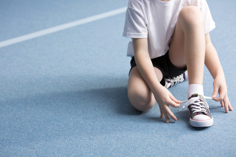 bigstock kid tying shoe