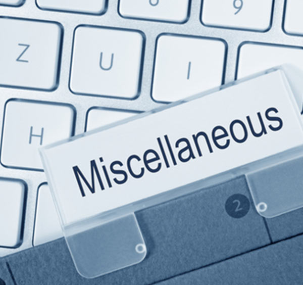 A white computer keyboard with a name tag labeled "Miscellaneous."