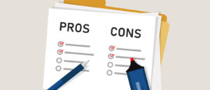 Pen hovering over paper with "Pros and Cons" written on it sitting on top of a folder.