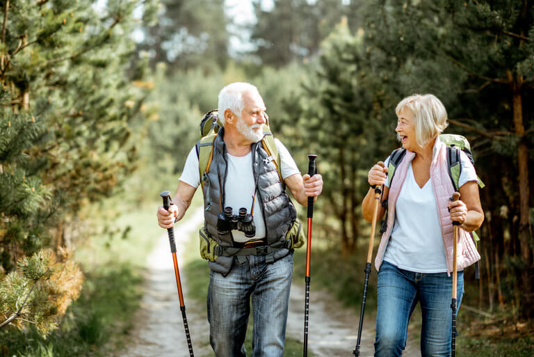 Couple hiking in woods who avoided estate planning mistakes