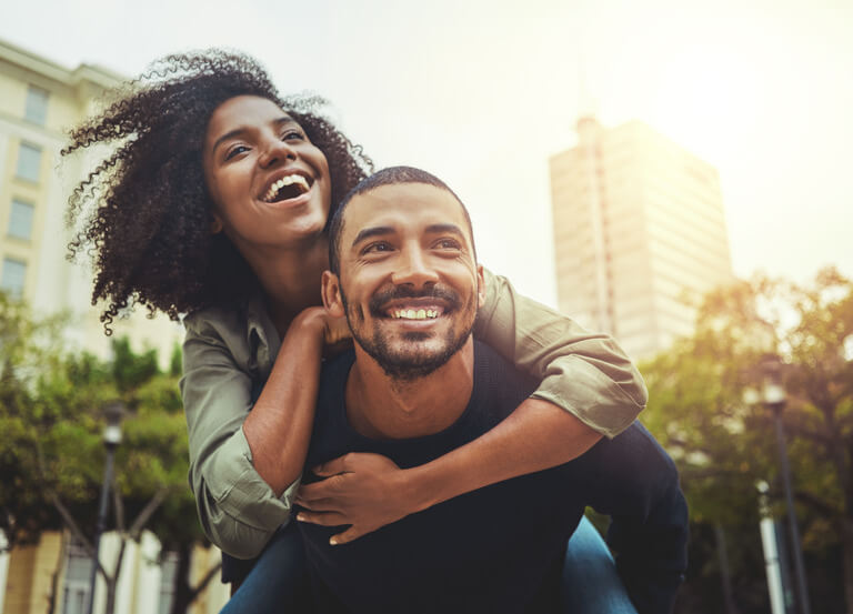 Young couple playing outside after setting up an estate plan