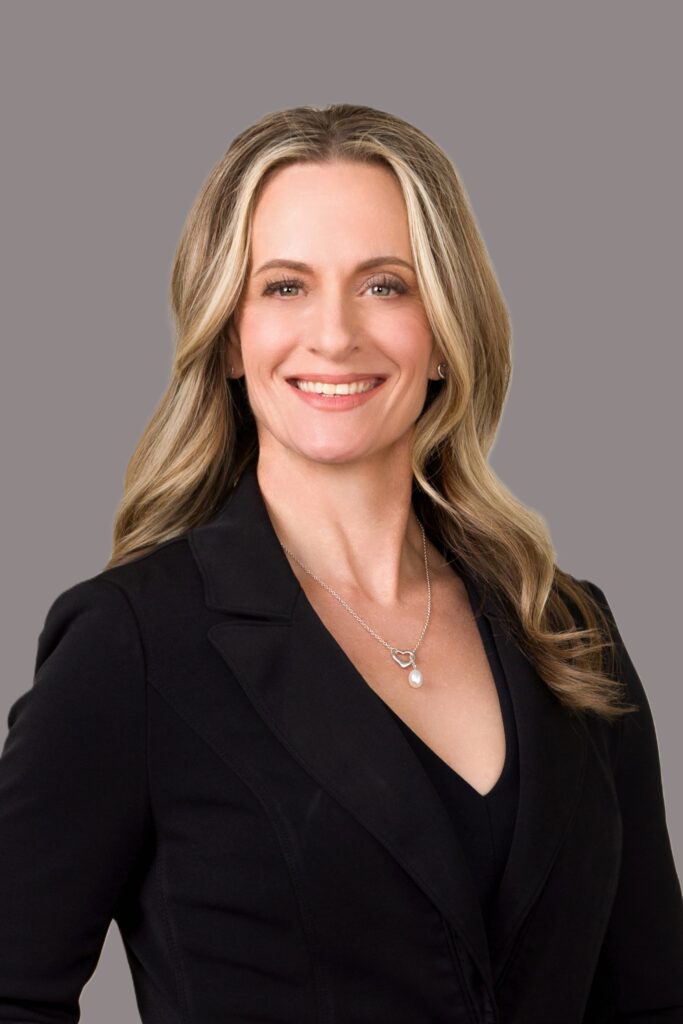Professional headshot of Molly Rosenblum, lead attorney at Rosenblum Allen Law Firm, wearing a black blazer and pendant necklace against a gray background.